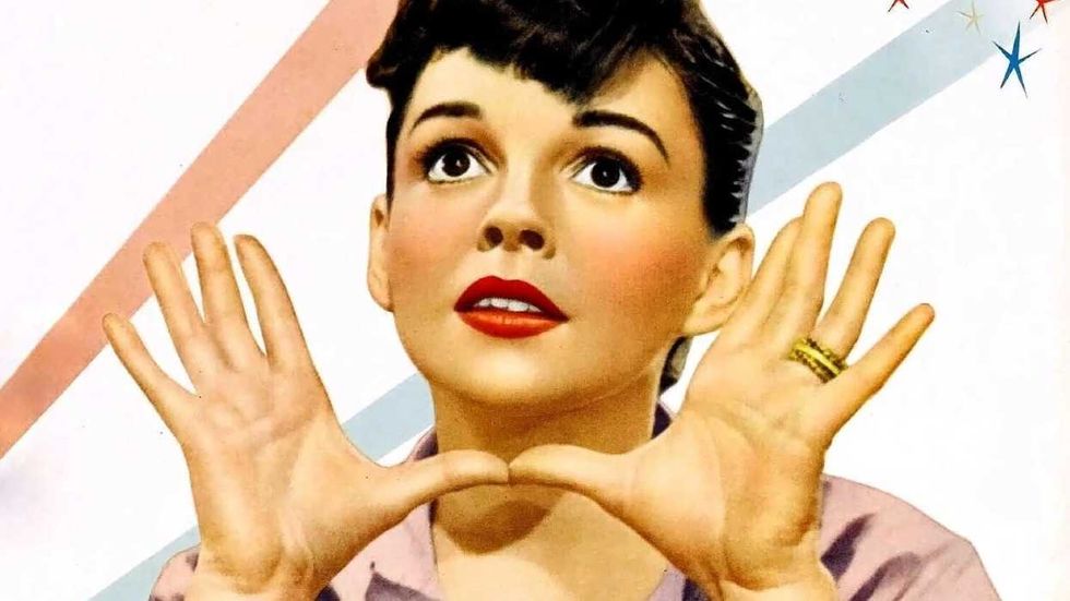 Judy Garland spreading her hands on the poster for A Star is Born 1954