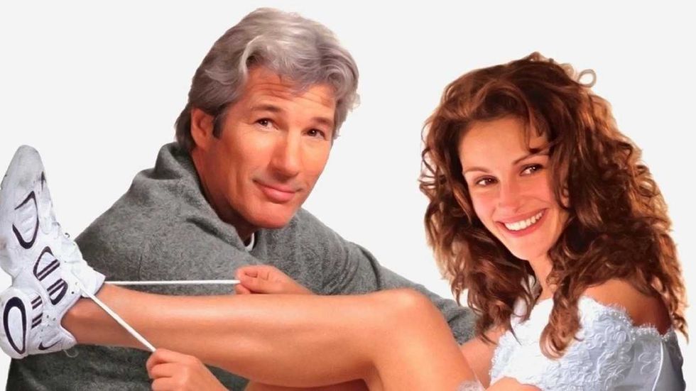 Julia Roberts lacing up sneakers in front of Richard Gere on the poster for Runaway Bride