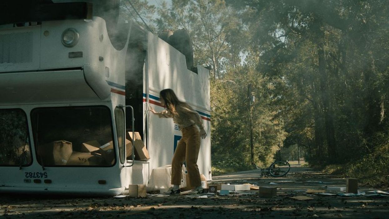Kaitlyn Dever as Brynn checking a flipped over mail truck in 'No One Will Save You'