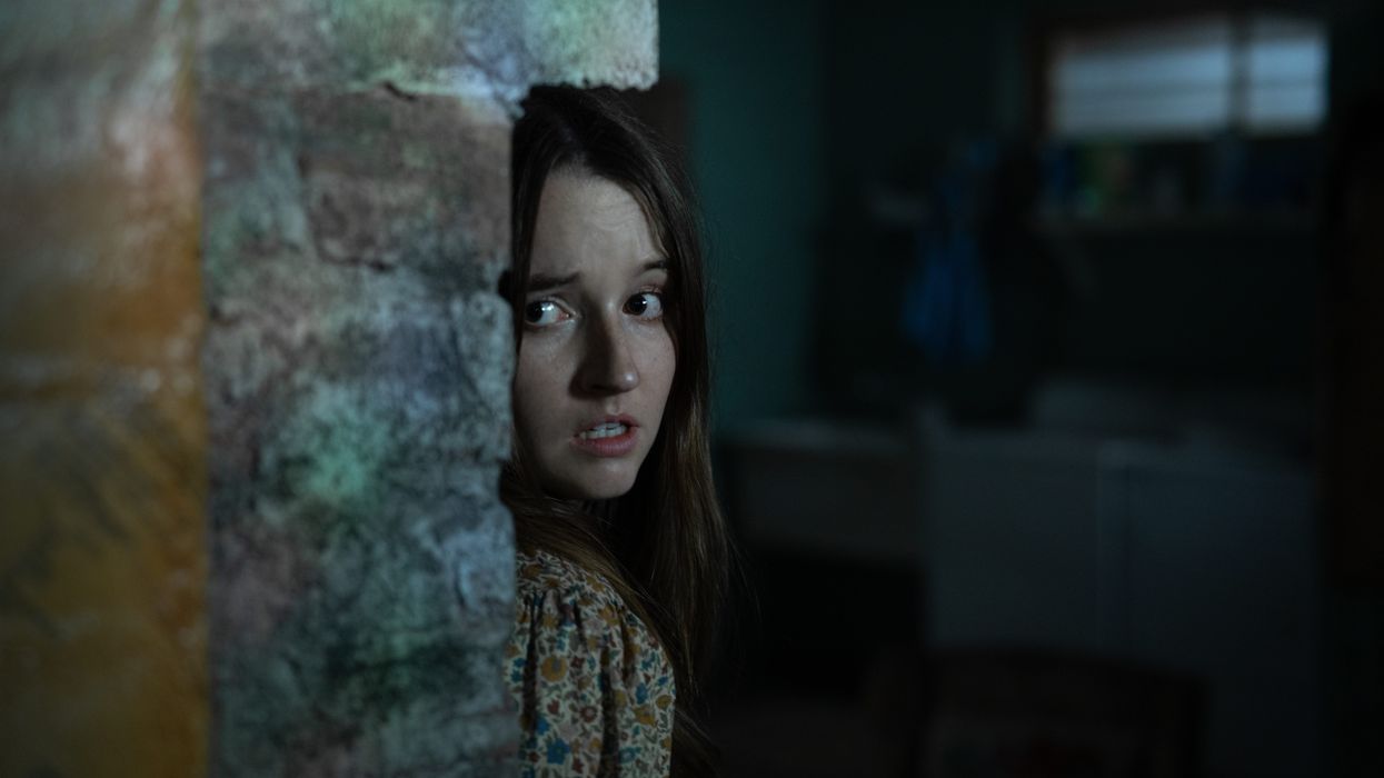 Kaitlyn Dever as Brynn hiding in 'No One Will Save You'