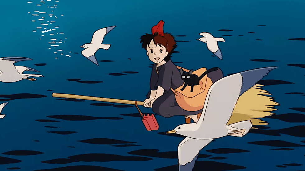 Kiki and her black cat Jiji flying over the sea on a broomstick in the Studio Ghibli film Kiki's Delivery Service