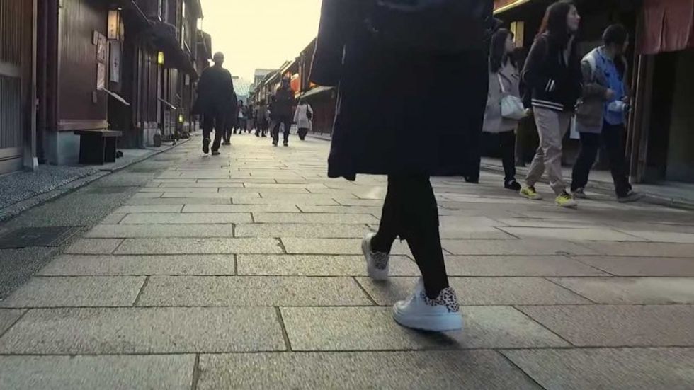Knee Level Shot of someone walking through a crowded street