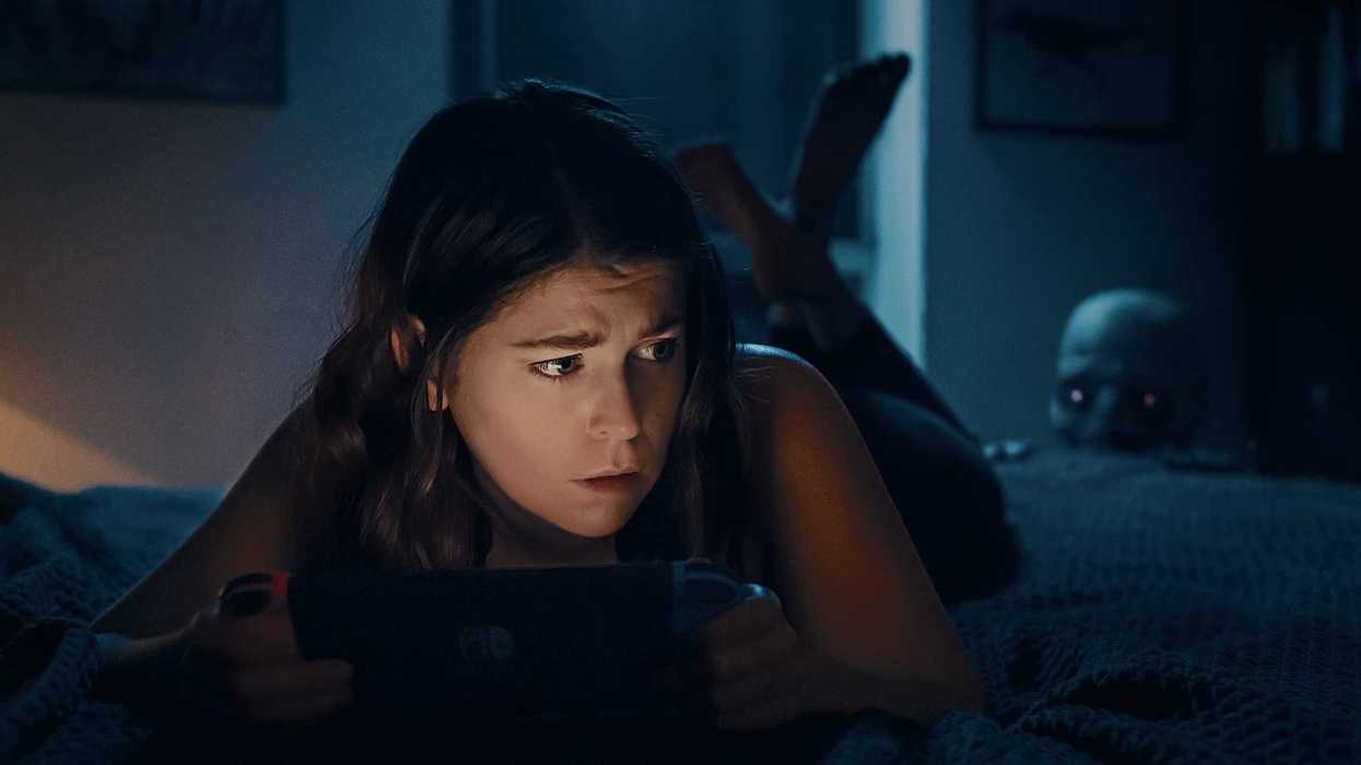 Late at night, a young woman plays Animal Crossing in the dark.