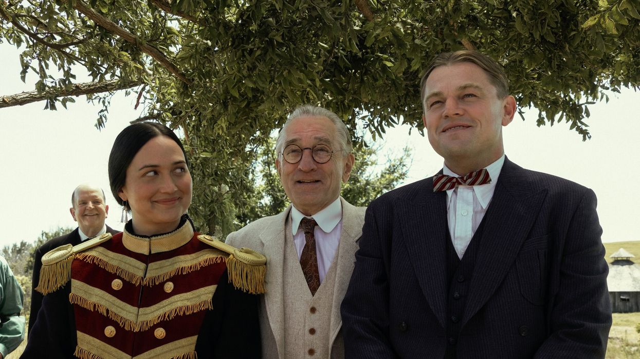 Leonardo DiCaprio as Ernest Burkhart, Robert De Niro as William King Hale, and Lily Gladstone as Mollie Burkhar standing together in 'Killers of the Flower Moon'