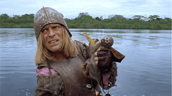 Lope de Aguirre holding a small monkey on a raft in Aguirre, the Wrath of God (1972)