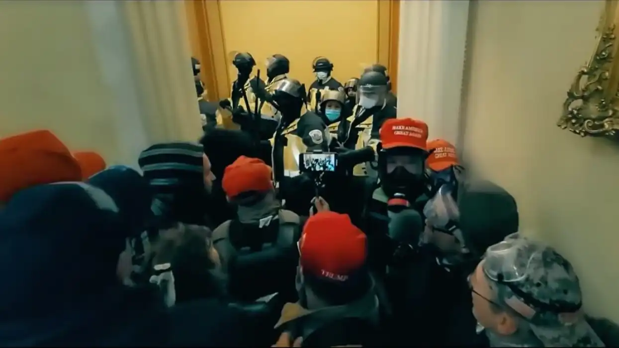 maga hat man wears gas mask inside capitol
