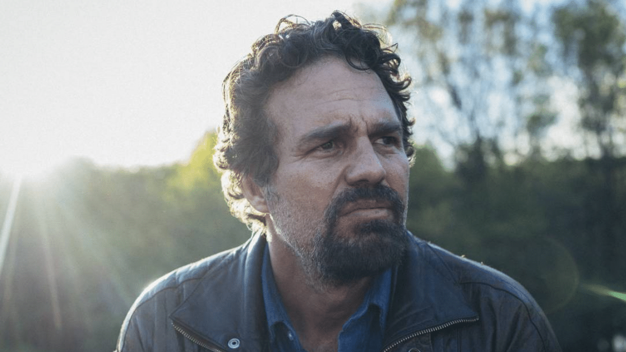 Mark Ruffalo sitting in a field, 'The Invisible Hand'