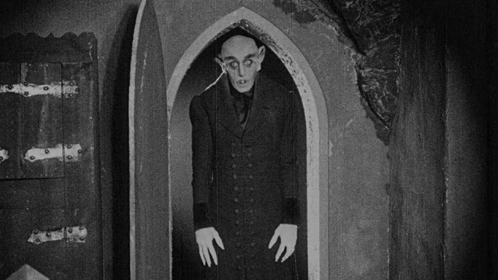 Max Schreck as Count Orlok standing in a doorway in Nosferatu