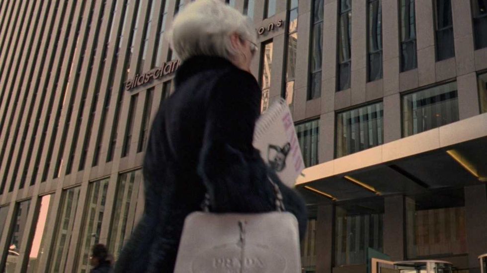 Meryl Streep as Miranda Priestly shot from behind while approaching the Runway building in The Devil Wears Prada