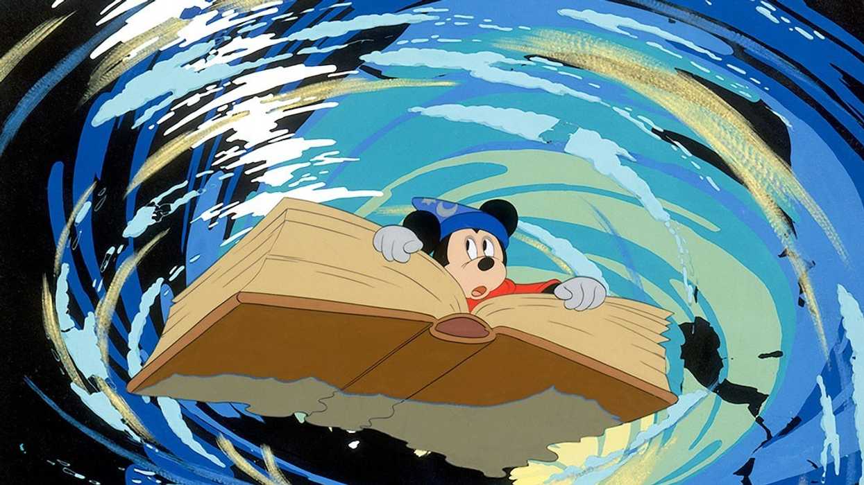 Mickey Mouse in his sorcerer's apprentice costume on a book in 'Fantasia'