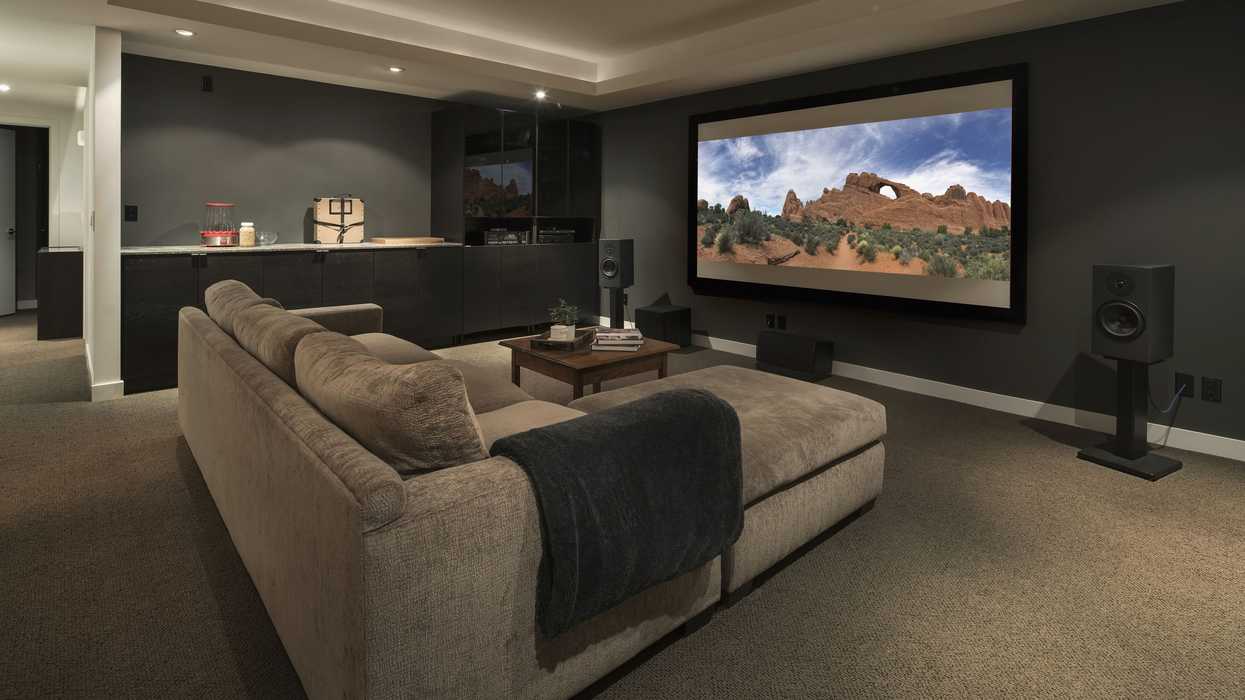 Movie-playing-on-projection-screen-in-home-theater-915093896-5bdb7eb0c9e77c0026d2970f
