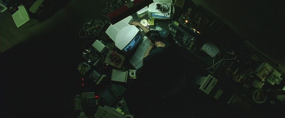 Neo, played by Keanue Reeves, sleeping at his messy desk, 'The Matrix'