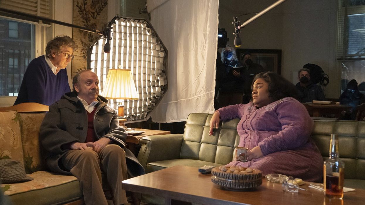 Paul Giamatti as Paul Hunham and Da'Vine Joy Randolph as Mary Lamb sitting on a couch at a Christmas party in 'The Holdovers'