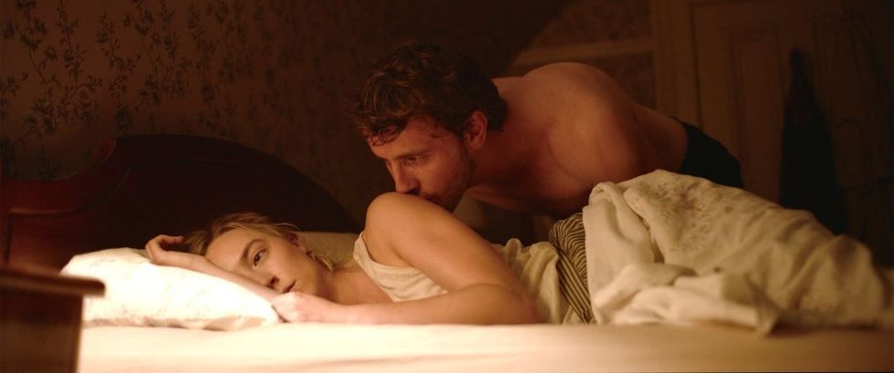 Paul Mescal as Junior kissing Saoirse Ronan as Henrietta as she lays in bed in 'Foe'