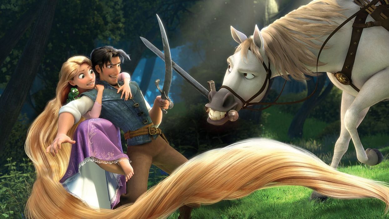 Rupunzel on Flynn Rider's back while he sword fights with Maximus in 'Tangled'