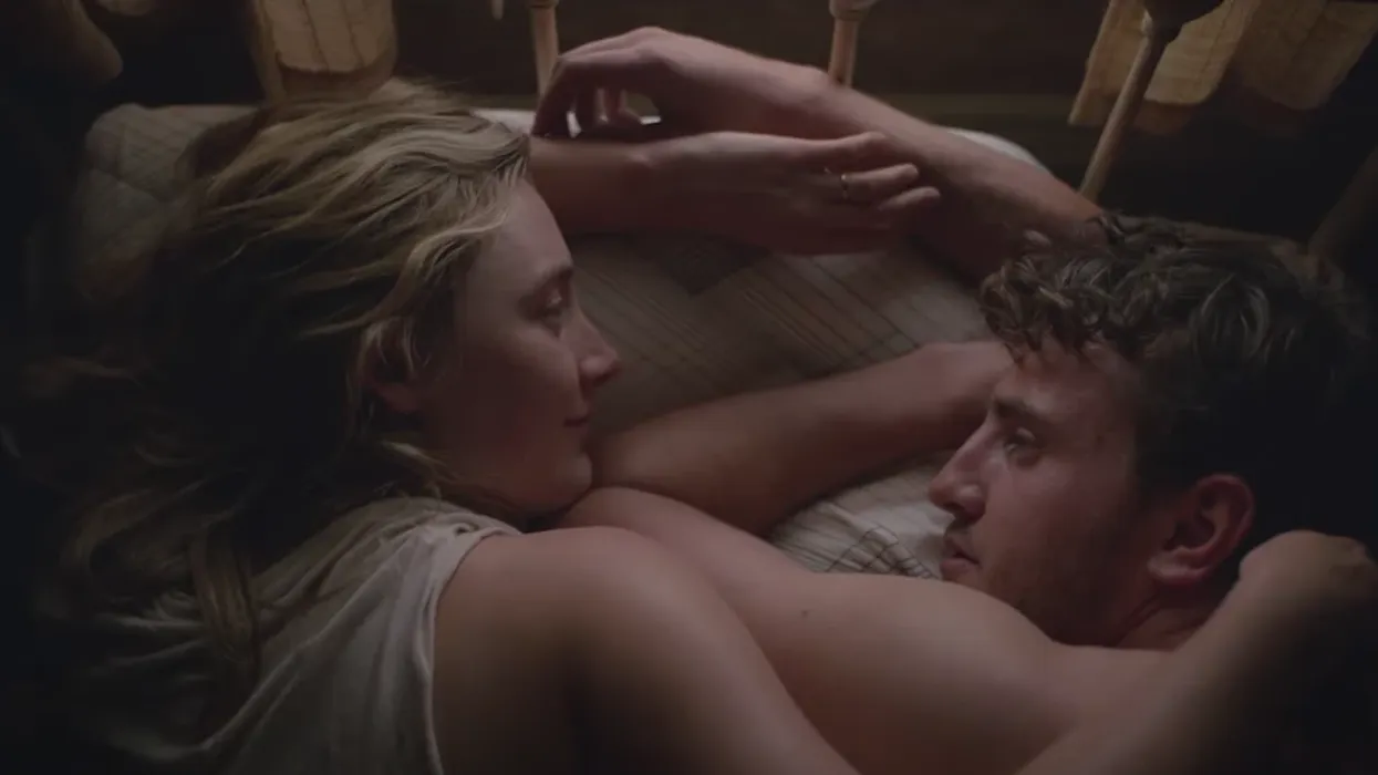 Saoirse Ronan as Henrietta and Paul Mescal as Junior laying in bed in 'Foe'