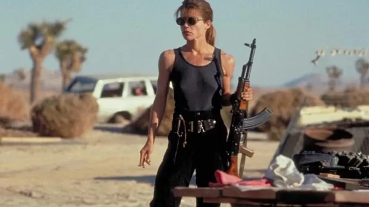 Sarah Connor, played by Linda Hamilton, holding a gun in the desert in 'Terminator 2: Judgement Day'