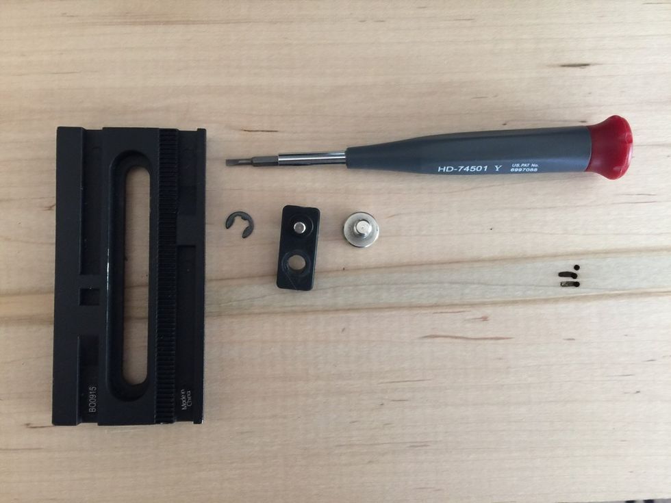 Screw removed from tripod quick release plate