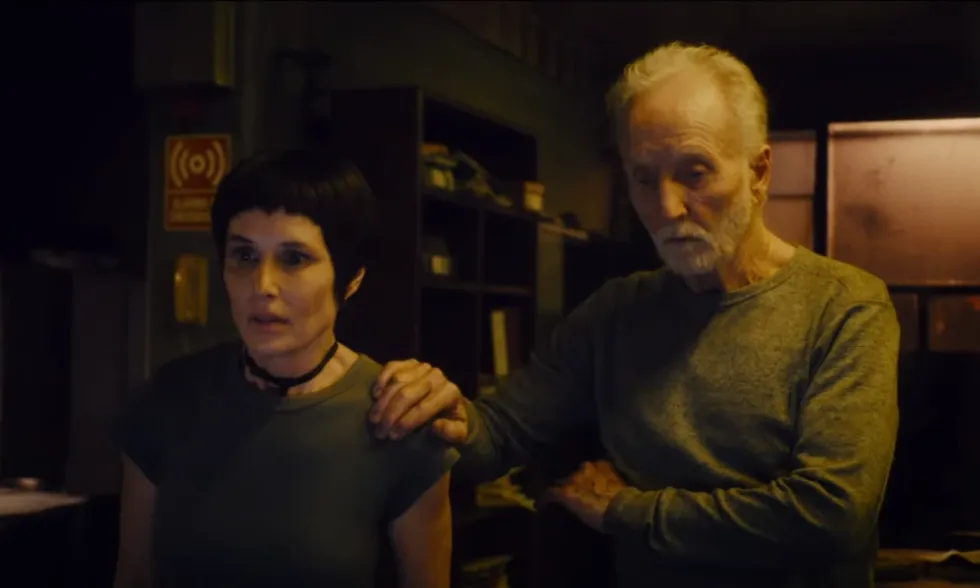 Shawnee Smith as Amanda Young and Tobin Bell as John Karmer watching a game in 'Saw X'