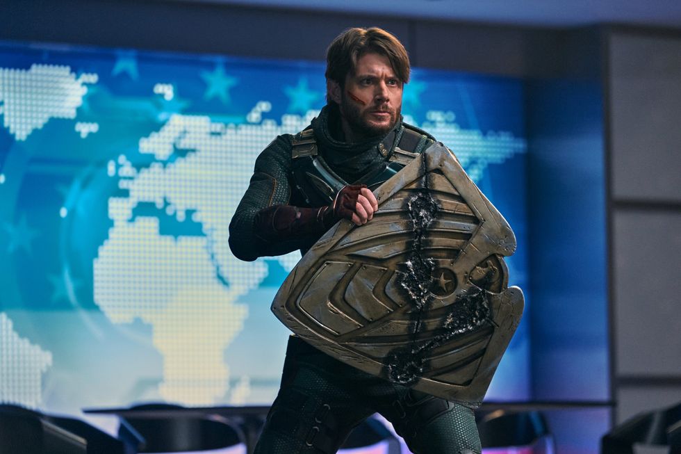Soldier Boy, played by Jensen Ackles, holding a scarred shield in 'The Boys'