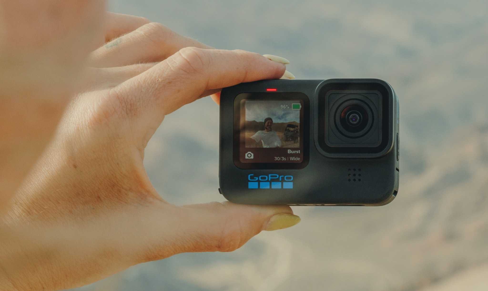 Someone holding a GoPro between their fingers.