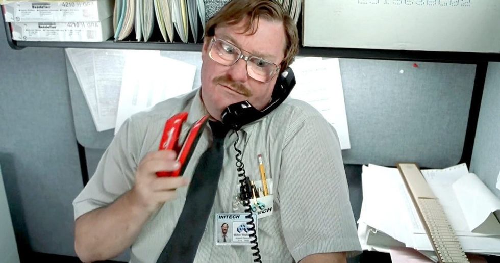 Stephen Root as Milton Waddams talking on the phone while holding a stapler in 'Office Space'