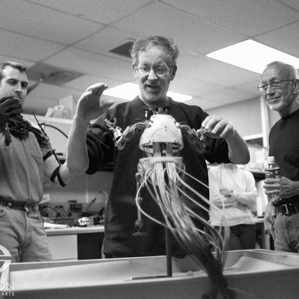 Steven Spielberg reacts to a mechanical demonstration of the Teddy supertoy by SWS mechanical designer Matt Heimlich, as Stan Winston looks on.