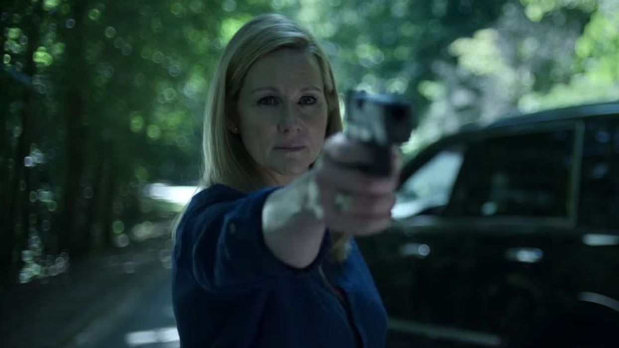 Stilll from OZARK Season 3, Laura Linney pointing a gun toward the camera