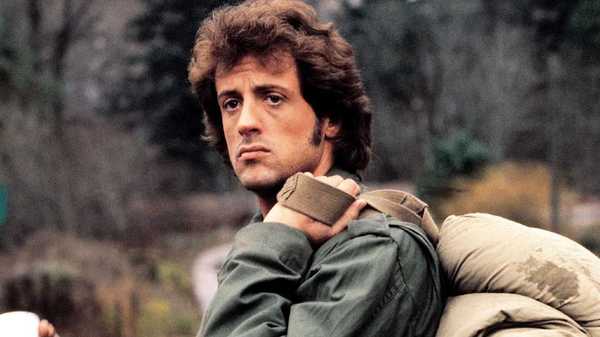 Sylvester Stallone as John Rambo holding a rucksack in First Blood