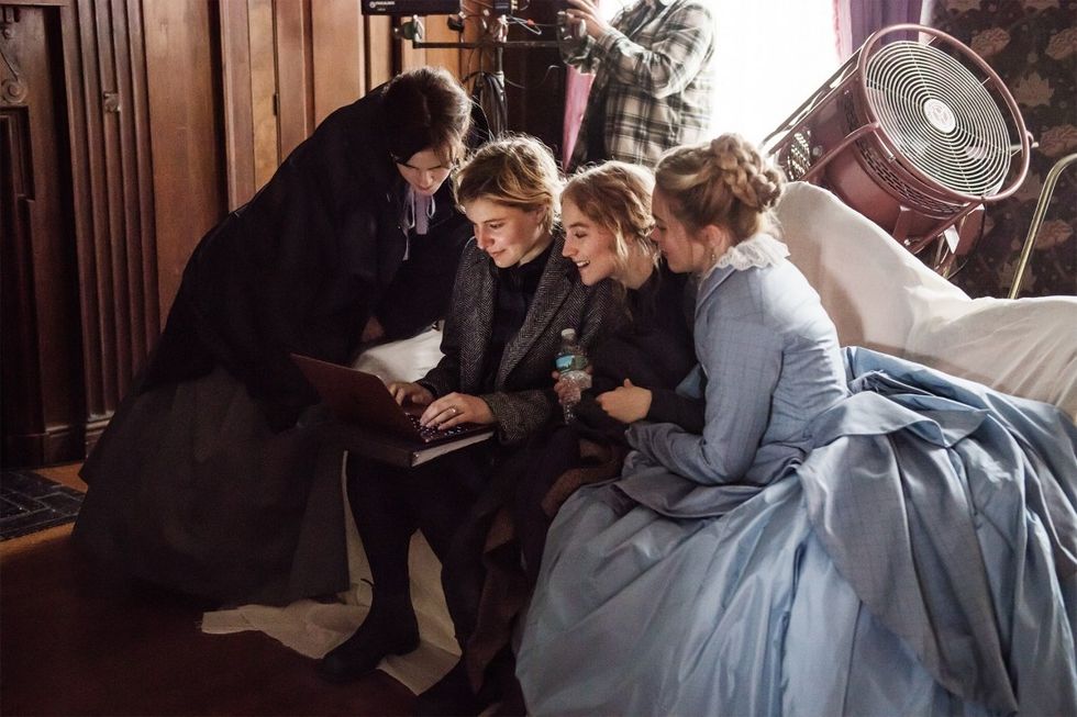 The cast of 'Little Woman' watching Greta Gerwig type on her computer.