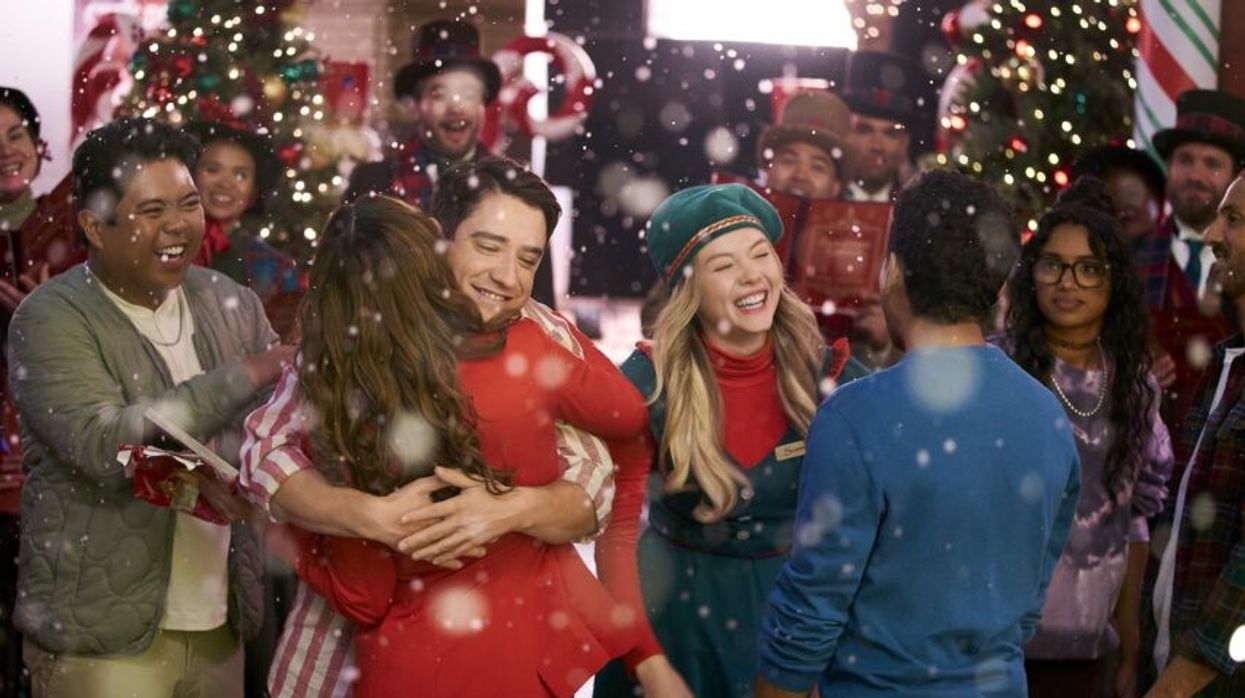 The cast of 'The Holiday Shift' laughing as it snows 