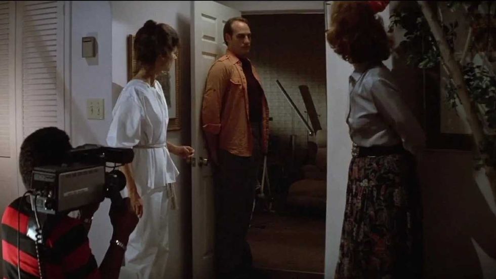 The Freelings and Dr. Lesh waiting for Tangina to emerge from the living room door in Poltergeist