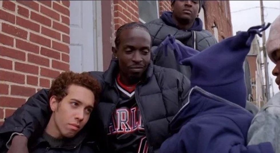 Three men sitting on a stoop in 'The Wire'