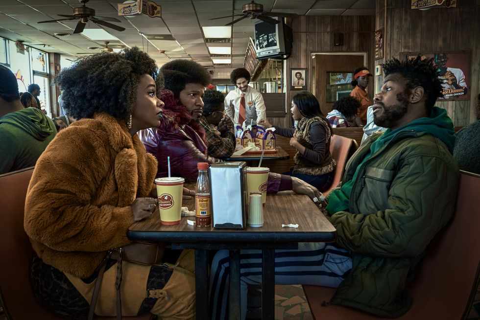 Three people eating at a fried chicken fast food resturant