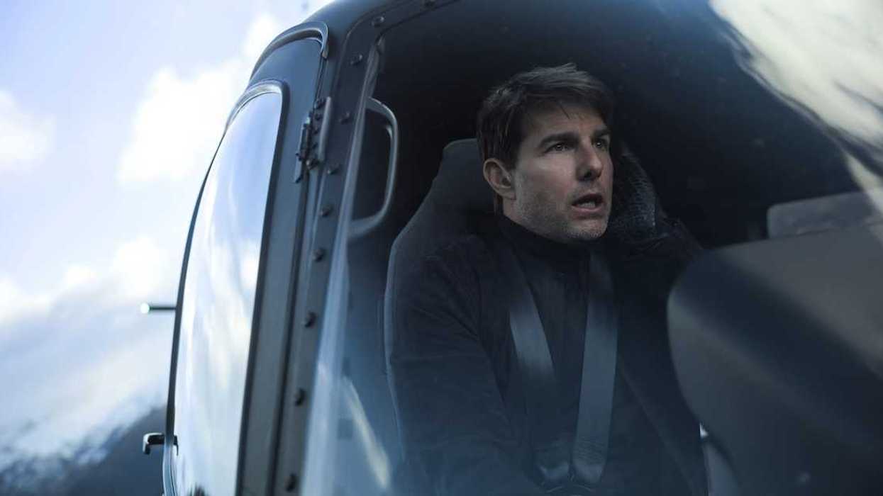 Tom Cruise as Ethan Hunt is flying a helicopter in Mission: Impossible - Fallout