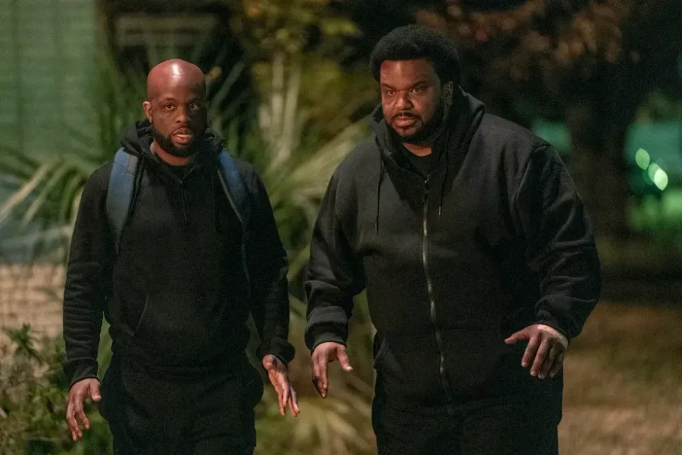 Two men dressed in black in 'Killing It'