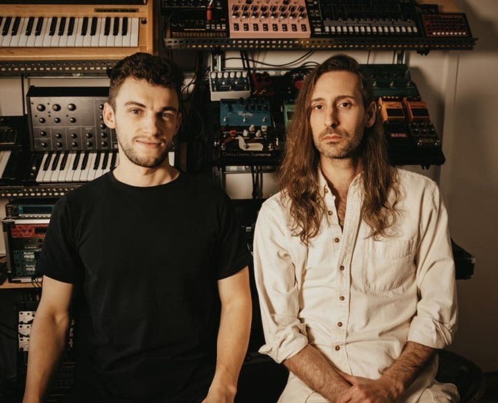 Two men sitting in front of keyboards