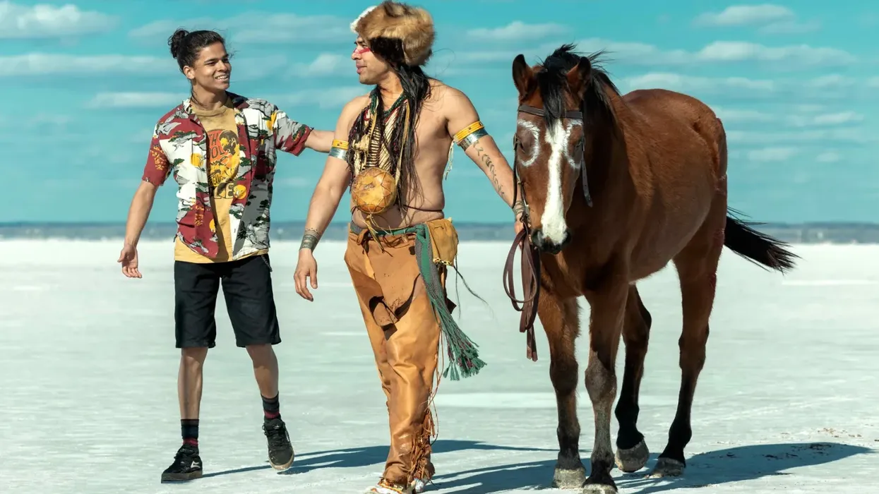 Two Native Americans walking next to a horse in 'Reservation Dogs'