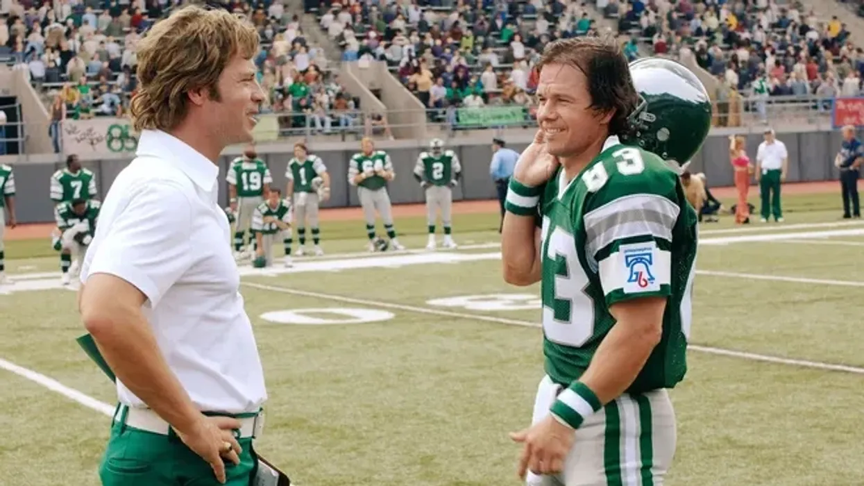 Vince Papale, played by Mark Wahlberg, and Dick Vermeil, played by Greg Kinnear, on a football field, 'Invincible'