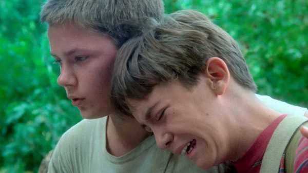 Wil Wheaton as Gordie crying on River Phoenix as Chris' shoulder in Stand by Me
