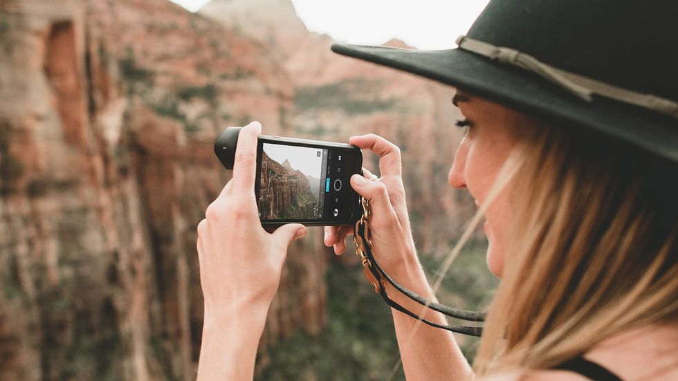 woman holding an iPhone using Pro Camera 5.0