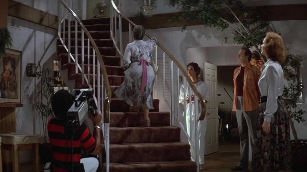 Zelda Rubinstein as Tangina climbing the staircase in Poltergeist
