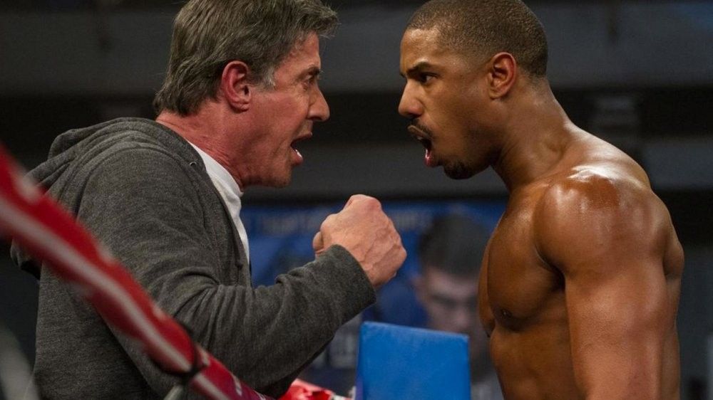 Two men yelling at each other in a boxing ring, 'Creed'