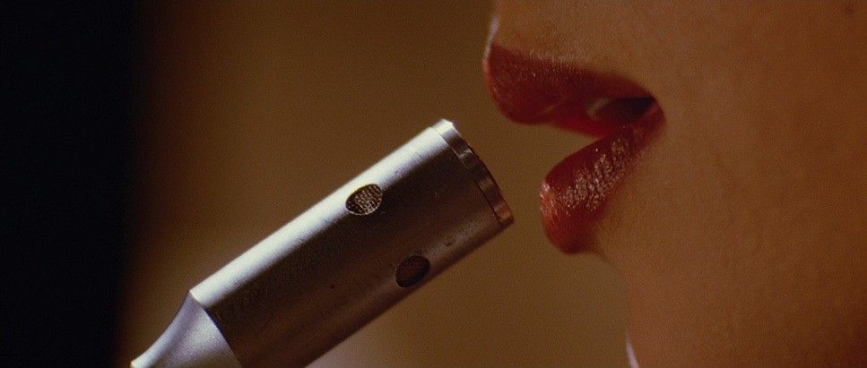 A pair of red lips speaking into a mircophone in 'Pulp Fiction'