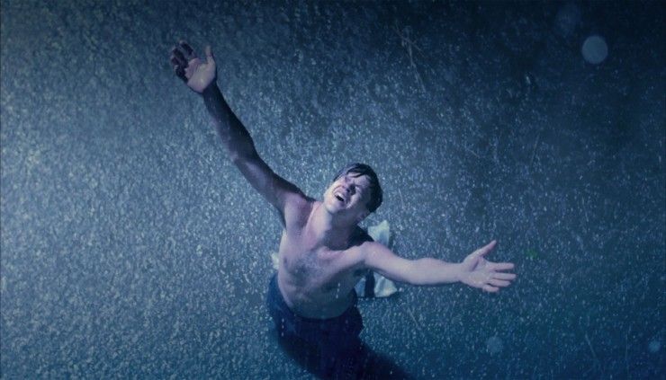Tim Robbins as Andy Dufresne arms up in the rainy night in 'The Shawshank Redemption'