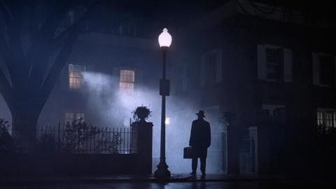 A Catholic priest standing outside a house in 'The Exorcist'